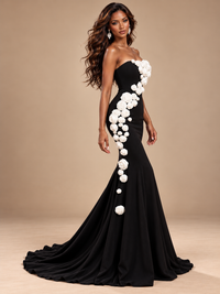 Asymmetrical white rose appliques decorating the fitted waist and hip of Jovellee's black mermaid gown