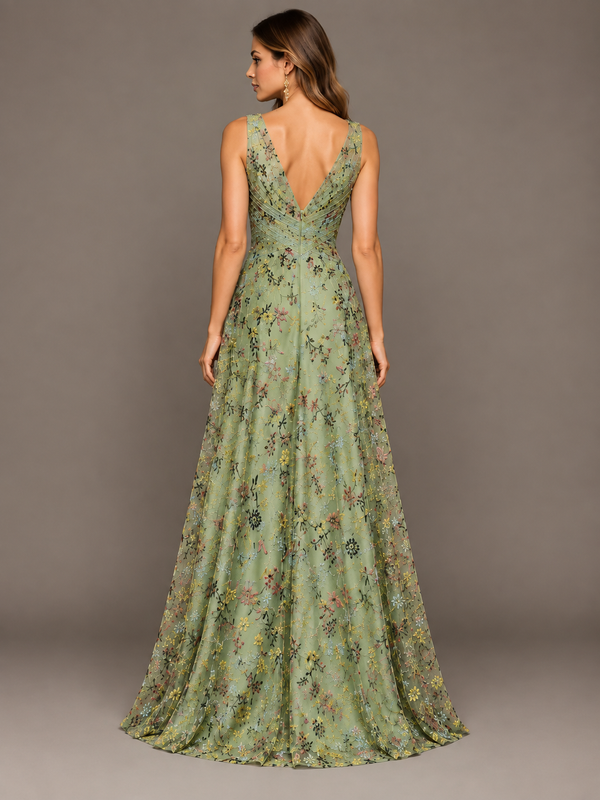 Back view of a woman wearing a sage green floral embroidered evening gown with V-back design and flowing full-length skirt
