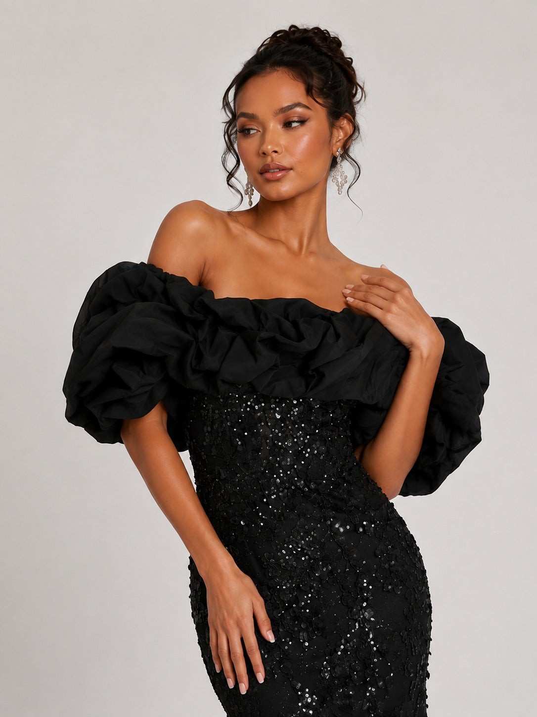 Oversized ruffle neckline on black sequin prom dress