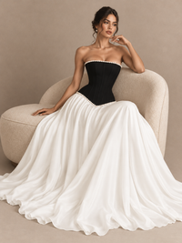 Black and white corset prom dress by Jovellee featuring a structured bodice, pearl accents and A-line silhouette