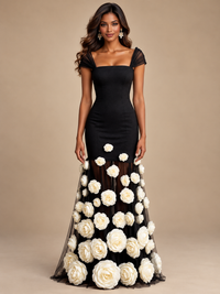 Black and white floral evening gown by Jovellee featuring a fitted bodice and sheer maxi skirt with oversized 3D roses