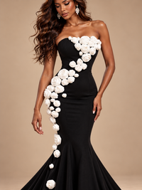 Black and white floral mermaid evening gown by Jovellee with a fitted bodice and asymmetrical rose appliques