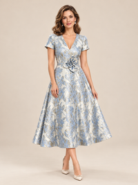 Blue floral A-line midi dress with short sleeves and statement flower waist detail