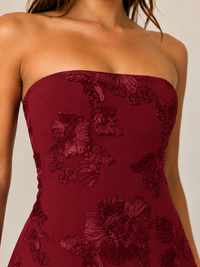 Burgundy strapless mini dress with floral embroidery, fitted corset bodice and elegant evening dress detail
