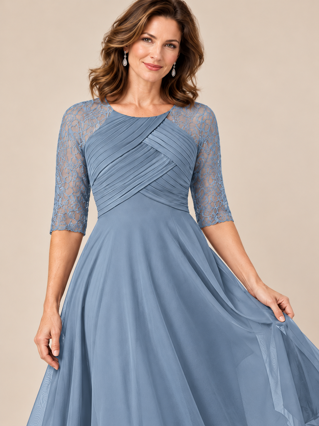 Close-up of crossover pleated bodice and defined waist on dusty blue formal dress