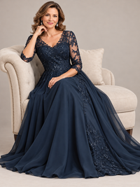 Close-up of floral lace appliqués and shimmering sequins on the fitted bodice of a navy blue mother of the bride dress