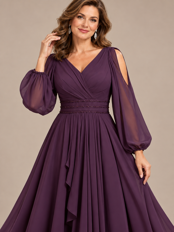 Close-up of pleated V-neck bodice and embellished waistband on plum mother of the bride gown