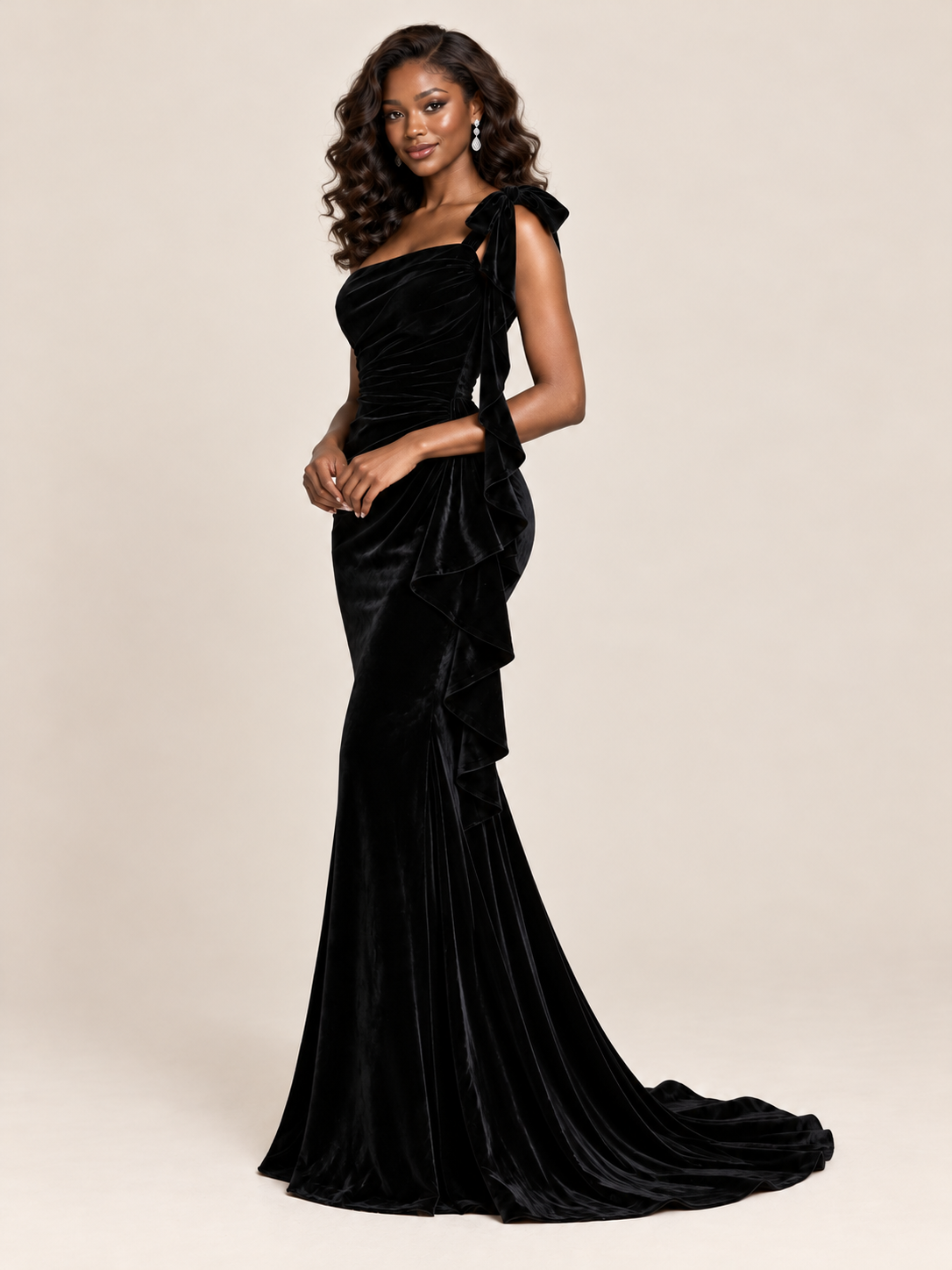 Close-up of the statement shoulder bow on Jovellee's black velvet one-shoulder evening dress
 
