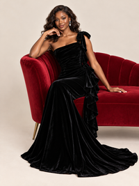 Diagonal ruching and draped waist detail on a fitted black velvet formal gown by Jovellee