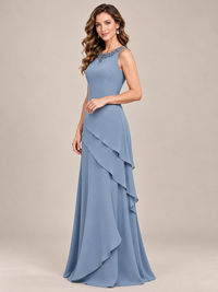 Dusty blue floor-length chiffon mother of the bride dress styled without its removable jacket