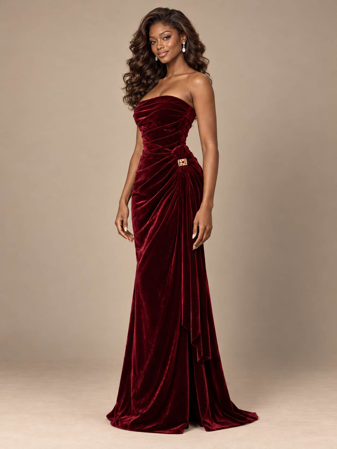 Elegant asymmetrical side drape falling from the hip of a burgundy strapless velvet gown