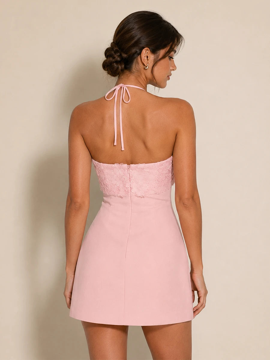 Back view of the Elodie pink floral applique halter mini dress with tie straps and open back