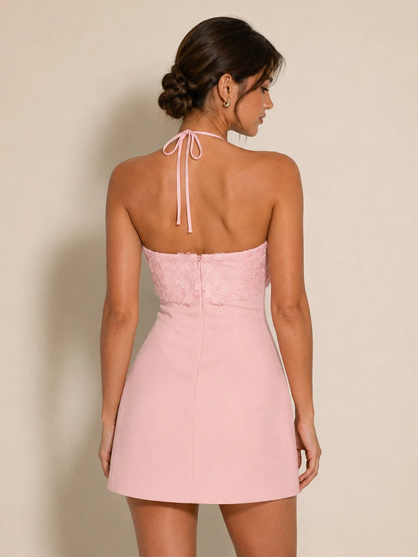 Back view of the Elodie pink floral applique halter mini dress with tie straps and open back