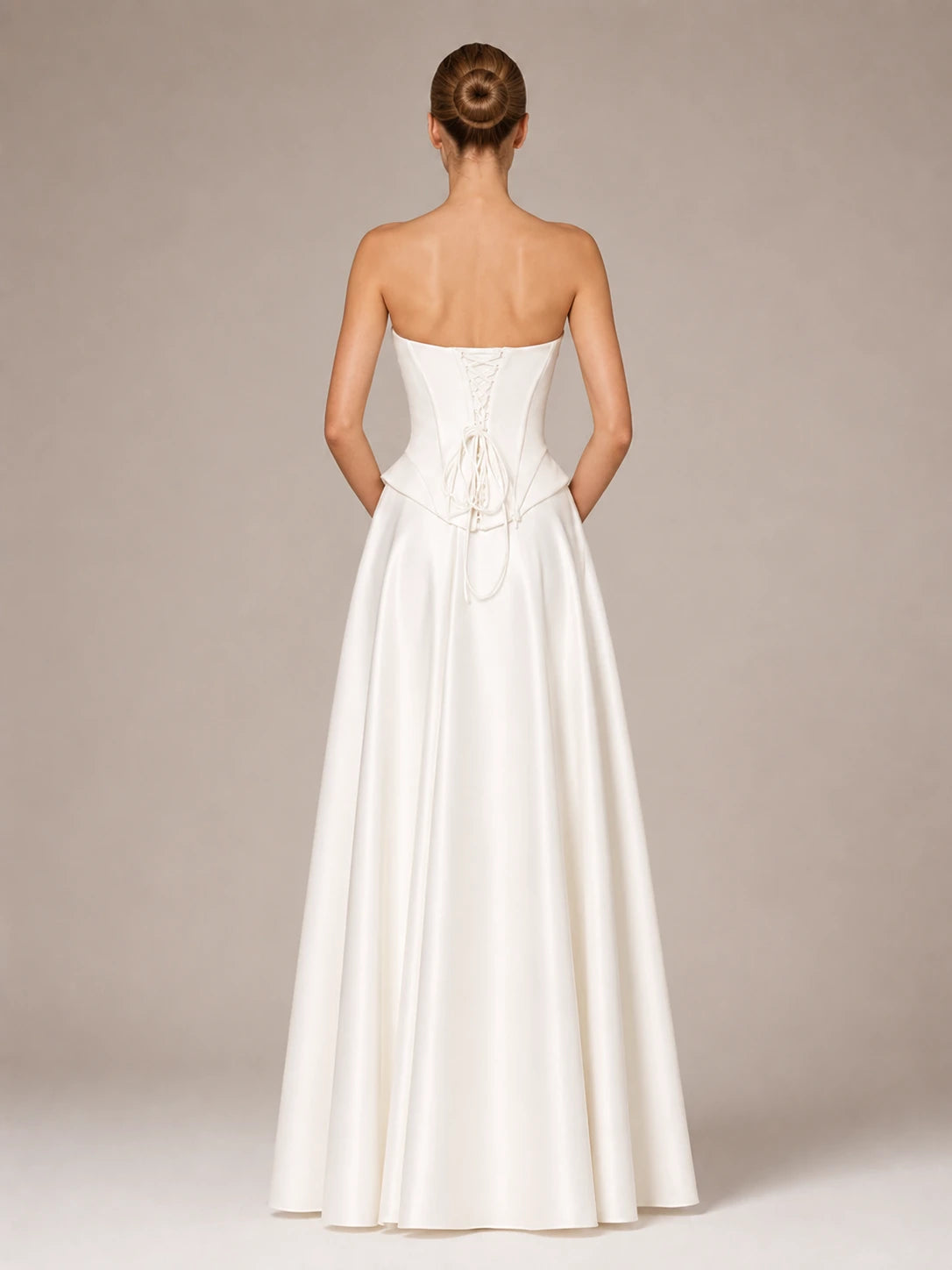 Back view of the Evangeline strapless satin ball gown wedding dress with lace-up corset closure