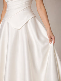 Close-up of the Evangeline white strapless wedding dress with draped satin bodice and straight neckline
