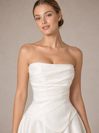 Close-up of the white satin fabric and sculpted basque waist on the Evangeline wedding dress