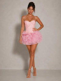 Three-quarter view of the Jovellee Fiora pink floral applique corset mini dress with voluminous mesh ruffles