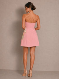 Back view of the Isadora pink strapless chiffon mini dress with A-line silhouette and back zipper