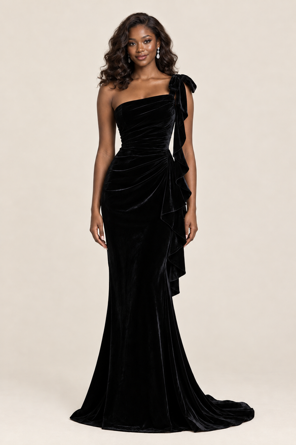 Jovellee black velvet one-shoulder evening gown with oversized shoulder bow, ruched bodice, cascading side ruffles and floor-length skirt