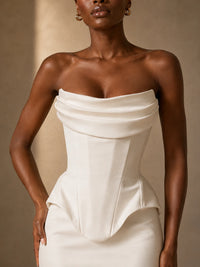 Close-up of the pointed basque waist and fitted column skirt on the Mira white satin wedding dress