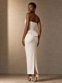 Back view of the Mira white satin corset wedding dress with a sculpted waist and rear skirt slit