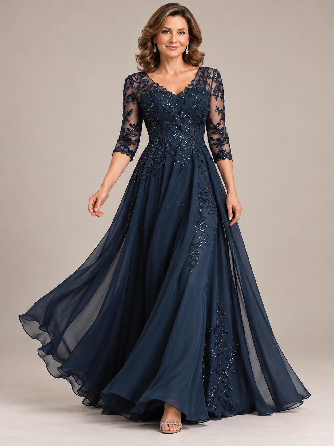Navy blue lace mother of the bride gown featuring a scalloped V-neckline, floral appliqués and sparkling sequin details