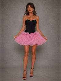 Full-length view of the Odette black corset pink tulle mini dress with dramatic ruffle skirt