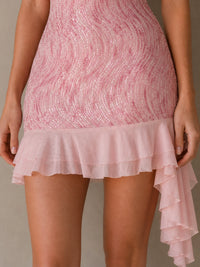 Close-up of the wave-pattern sequins and layered asymmetric ruffle hem on the Rosalie pink mini dress