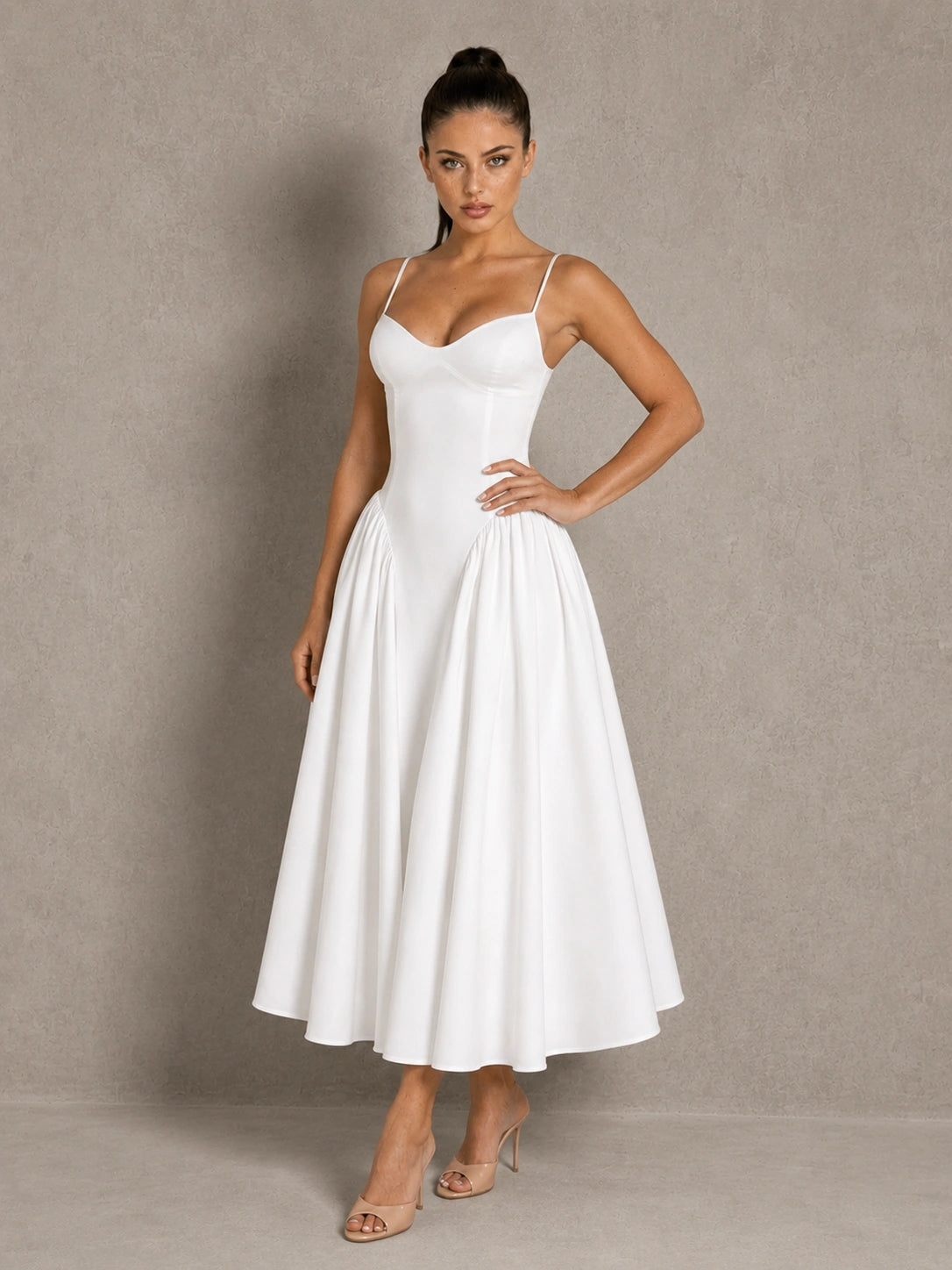 Full-length front view of the Jovellee Rosaline white Basque-waist midi wedding dress with the A-line skirt spread