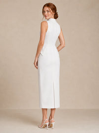 Back three-quarter view of the Jovellee Solenne white high-neck wedding dress with a fitted column silhouette and back slit