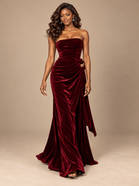 Elegant asymmetrical side drape falling from the hip of a burgundy strapless velvet gown