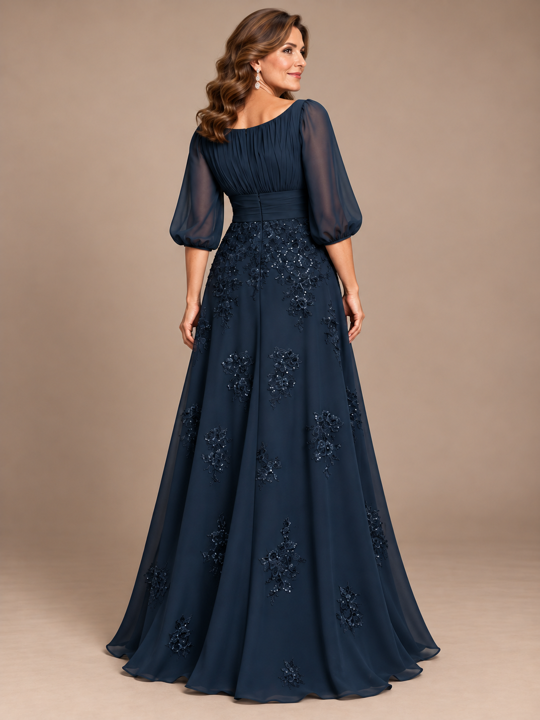 back view navy blue A-line mother of the bride dress with sheer puff sleeves and floral sequin appliqués  