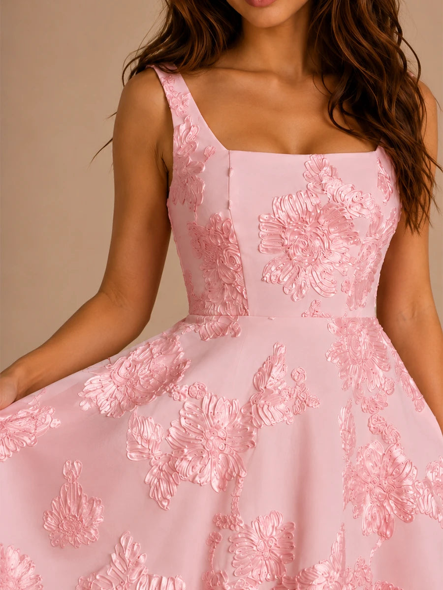 Close-up of blush pink 3D floral applique homecoming dress with square neckline, fitted bodice, and A-line skirt.