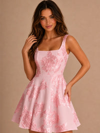 Three-quarter view of blush pink 3D floral applique homecoming dress with fitted bodice and flared mini skirt.