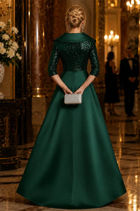 Back view of emerald green sequin mother of the bride gown with satin A-line overskirt and 3/4 sleeves.