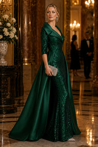 Side view of emerald green sequin mother of the bride gown with satin overskirt and fitted silhouette.